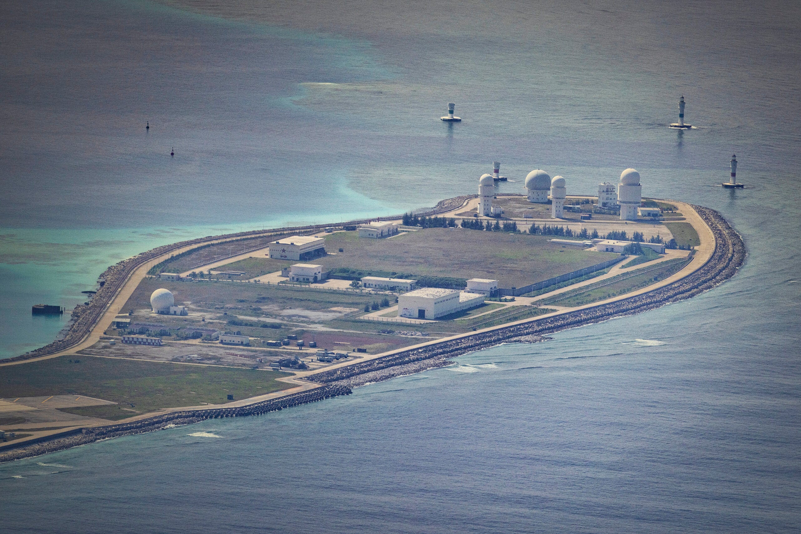 SPRATLY ISLANDS, AT SEA - OCTOBER 25: Buildings and structures are seen on the artificial island built by China in Mischief Reef on October 25, 2022 in Spratly Islands, South China Sea. China has progressively asserted its claim of ownership over disputed islands in the South China Sea by artificially increasing the size of islands, creating new islands and building ports, military outposts and airstrips. The South China sea is an important trade route and is of significant interest as geopolitical tensions remain high in the region. (Photo by Ezra Acayan/Getty Images)
