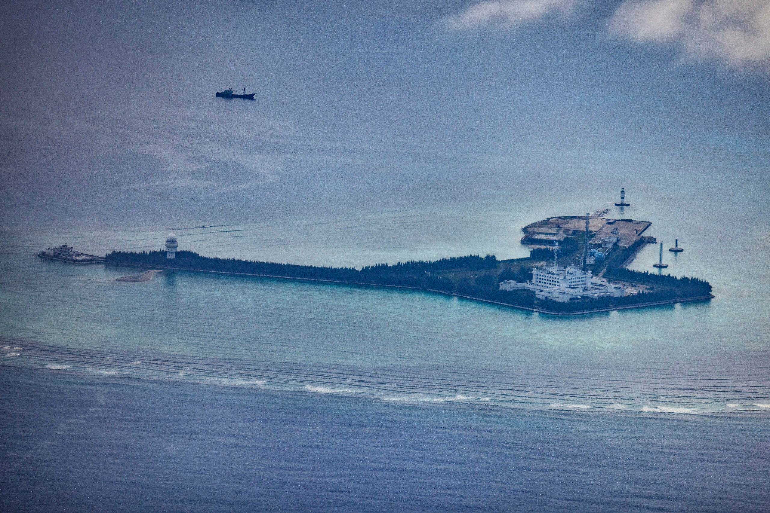 SPRATLY ISLANDS, AT SEA - OCTOBER 25: Buildings and structures are seen on the artificial island built by China in Gaven Reefs on October 25, 2022 in Spratly Islands, South China Sea. China has progressively asserted its claim of ownership over disputed islands in the South China Sea by artificially increasing the size of islands, creating new islands and building ports, military outposts and airstrips. The South China sea is an important trade route and is of significant interest as geopolitical tensions remain high in the region. (Photo by Ezra Acayan/Getty Images)