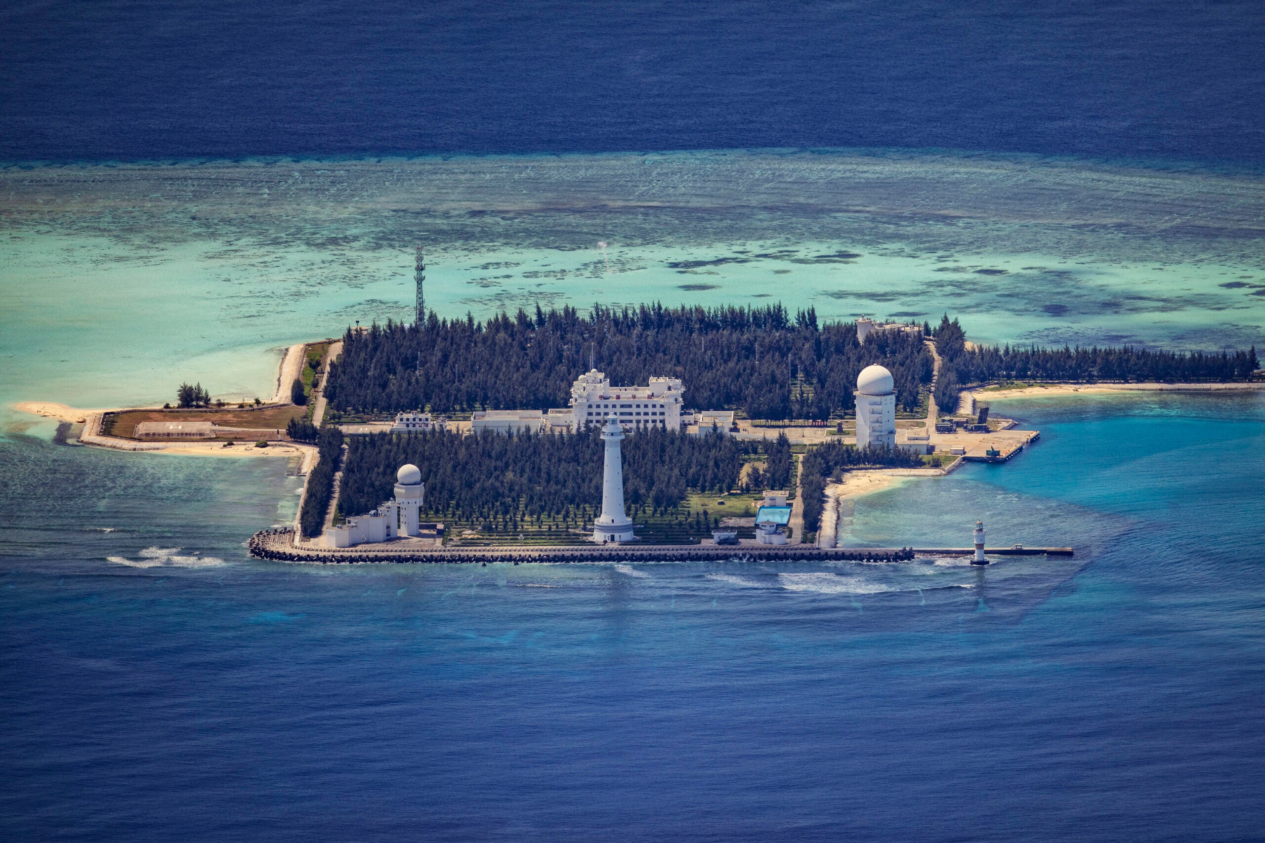 SPRATLY ISLANDS, AT SEA - OCTOBER 25: Buildings and structures are seen on the artificial island built by China in Cuarteron Reef on October 25, 2022 in Spratly Islands, South China Sea. China has progressively asserted its claim of ownership over disputed islands in the South China Sea by artificially increasing the size of islands, creating new islands and building ports, military outposts and airstrips. The South China sea is an important trade route and is of significant interest as geopolitical tensions remain high in the region. (Photo by Ezra Acayan/Getty Images)
