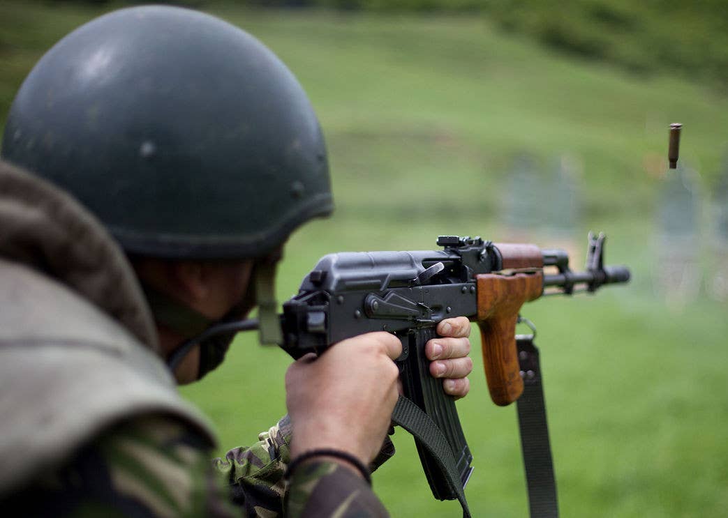 A Romanian soldier fires their PA md. 86 rifle. <em>DOD</em>