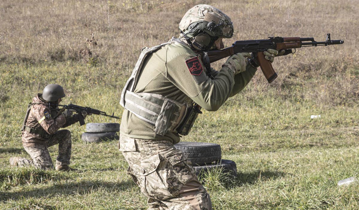 Ukrainian Territorial Defense Forces volunteers train with AK-74-type rifles. <em>Metin Aktas/Anadolu Agency via Getty Images</em>