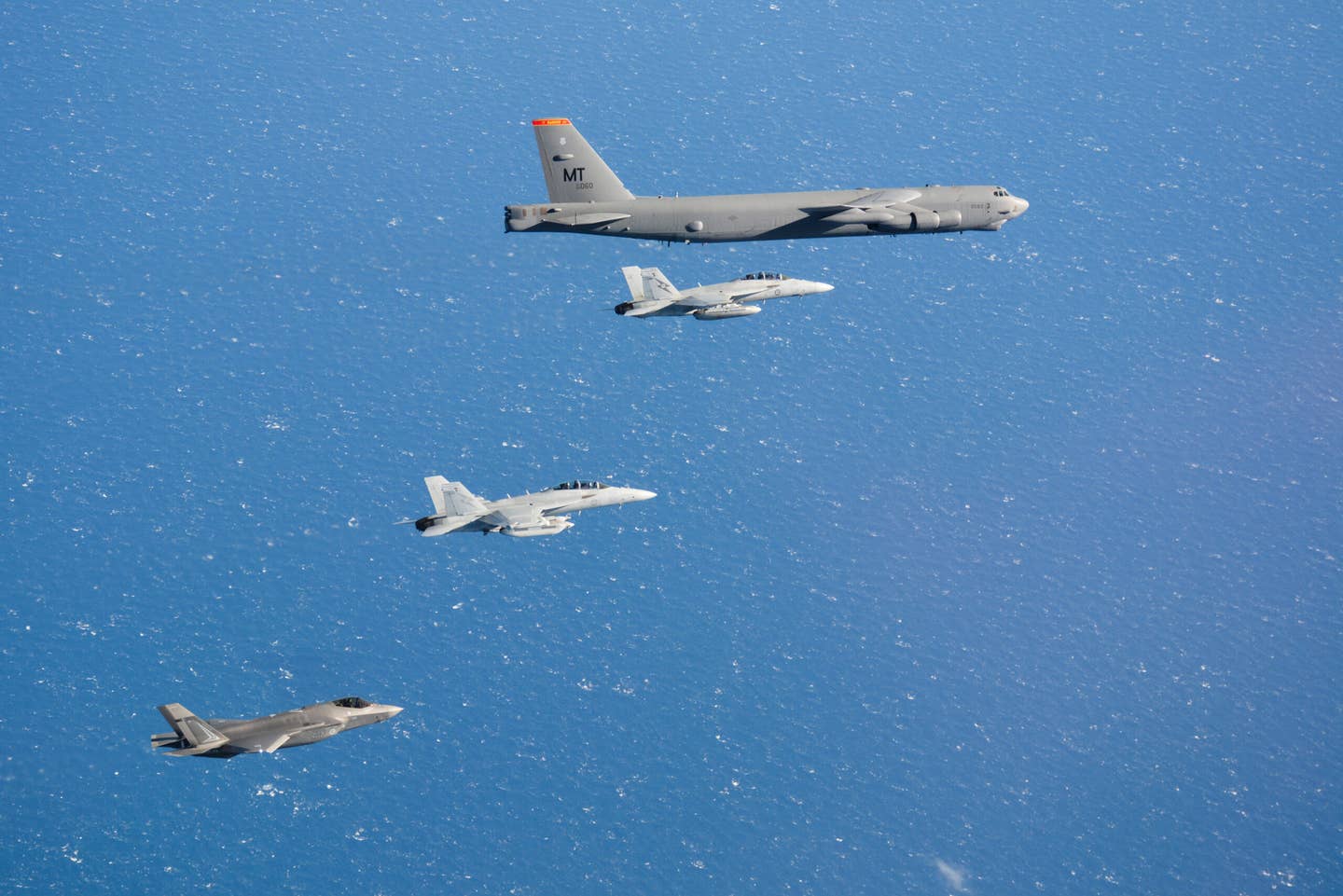 A RAAF F-35A Lightning II, EA-18G Growler, and F/A-18F Super Hornet fly alongside a U.S. Air Force B-52H from the 23rd Expeditionary Bomb Squadron based at Guam during Exercise Talisman Sabre 21. <em>Australian Department of Defense</em>