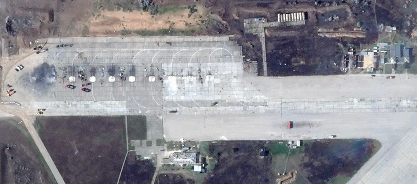 A close-up of the ramp at the southwestern end of Saki Air Base shows the remains of multiple aircraft. Fire trucks and other vehicles can be seen, as well. There is visible damage to the structures to the immediate south and east, too.&nbsp;<em>PHOTO © 2022 PLANET LABS INC. ALL RIGHTS RESERVED. REPRINTED BY PERMISSION</em>