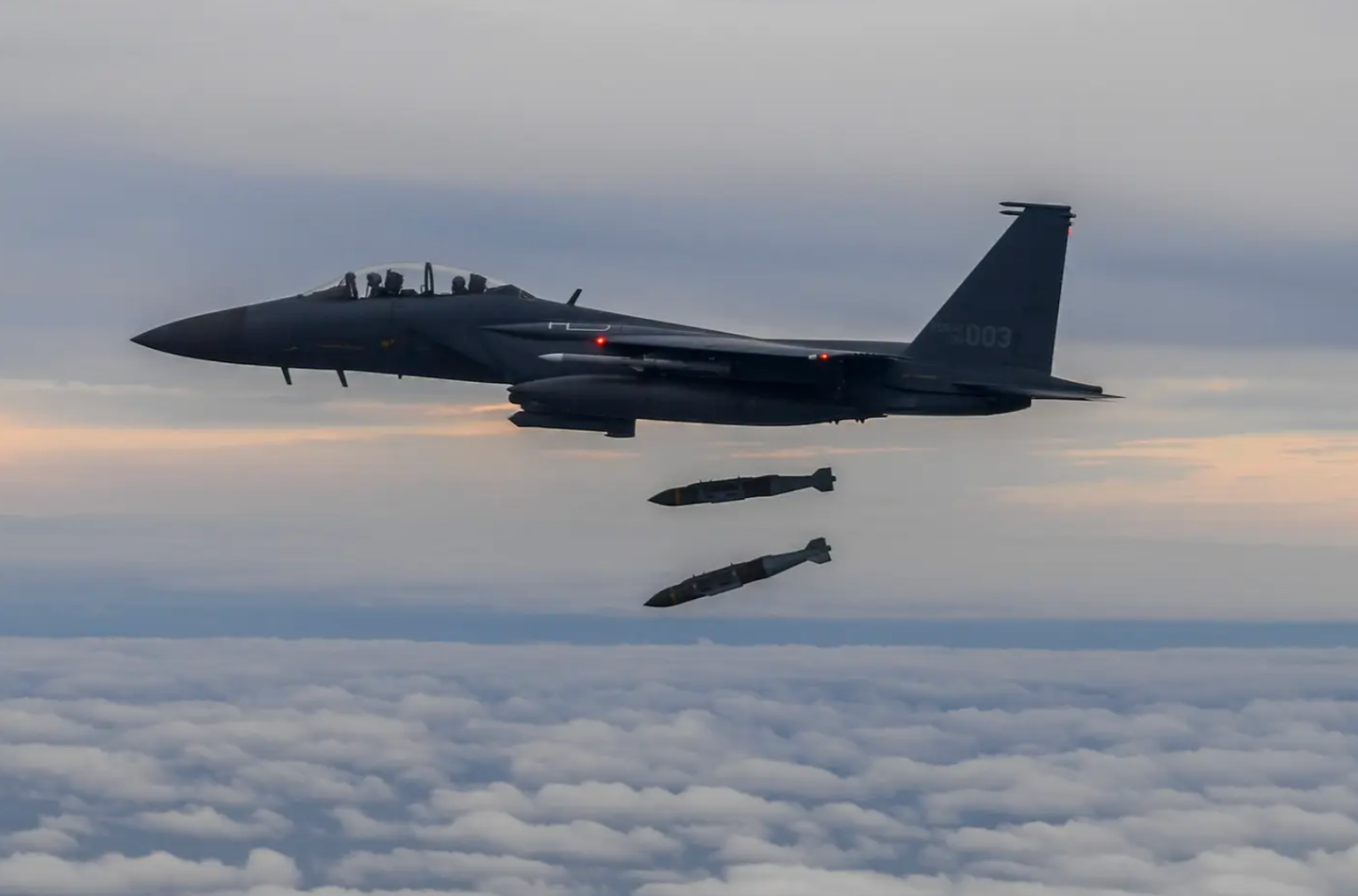 A photo released by the South Korean Defense Ministry shows a ROKAF F-15K dropping two Joint Direct Attack Munition (JDAM) bombs onto an island target in response to a North Korean IRBM launch, on October 4, 2022.&nbsp;<em>Photo by South Korean Defense Ministry via Getty Images</em>