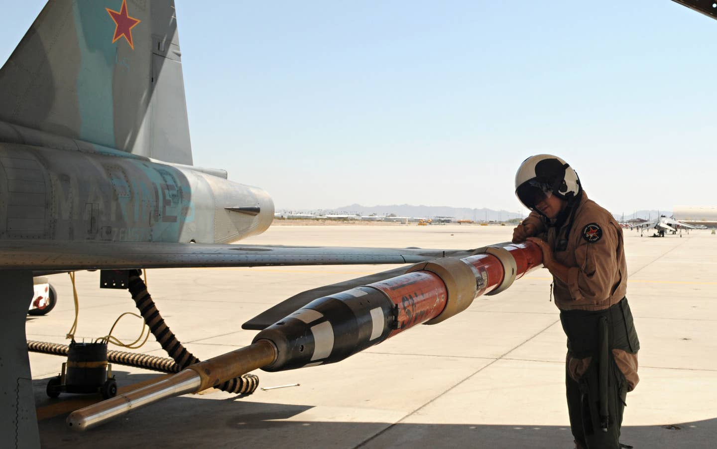 A pilot from Marine Fighter Training Squadron 401 checks the placement of a TCTS pod on an F-5E prior to takeoff at the Marine Corps Air Station Yuma, Arizona. <em>U.S. Marine Corps</em>