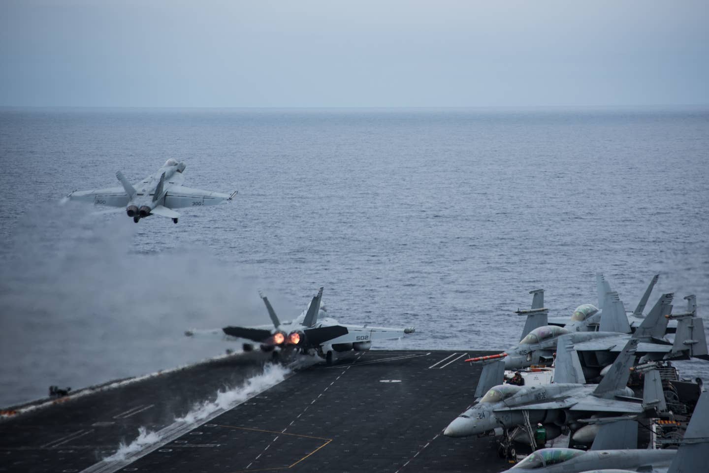 Two F/A-18 Super Hornets take off from the flight deck of the aircraft carrier USS <em>Theodore Roosevelt</em> during the COMPTUEX in the Pacific on August 19, 2017, three days before the crash of JEST 11. <em>U.S. Navy photo by Mass Communication Specialist 3rd Class Robyn B. Melvin/Released</em>