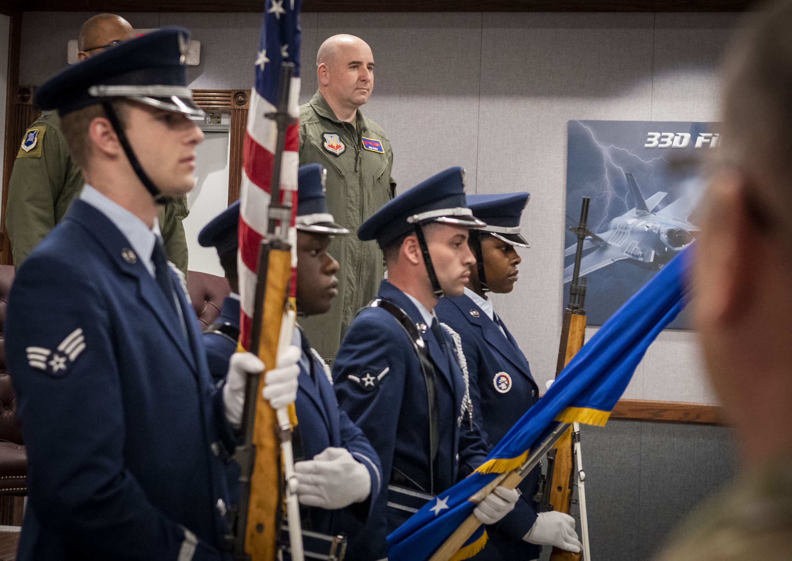Col. Robert Cocke stands at attention for the national anthem during the 350th Spectrum Warfare Group assumption of command ceremony at Eglin Air Force Base, Fla. March 18, 2022. <em>Credit: Air Force photo by Jaime Bishopp</em>