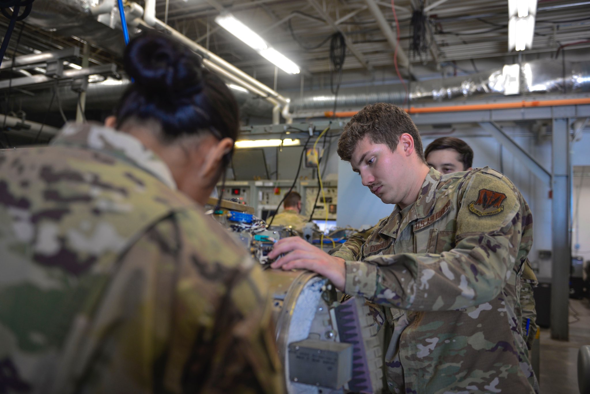 Members from the 36th Electronic Warfare Squadron work on an A4 module at Eglin Air Force Base, Florida, on August 29, 2022. <em>Credit: U.S. Air Force photo by Staff Sgt. Ericka A. Woolever</em>