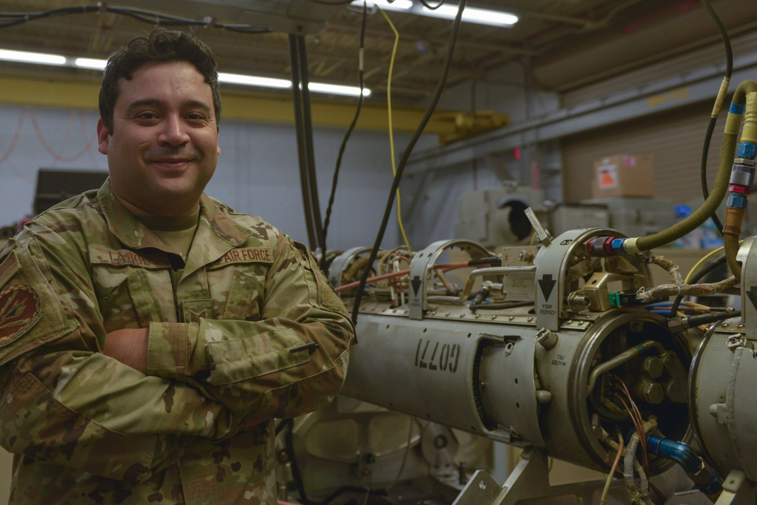 Staff Sgt. Harvey Large, 36th Electronic Warfare Squadron legacy lab section chief, poses for a photo in one of the wing's workshops used to develop new and improved EMS capabilities. <em>Credit: U.S. photo by Staff Sgt. Ericka A. Woolever</em>