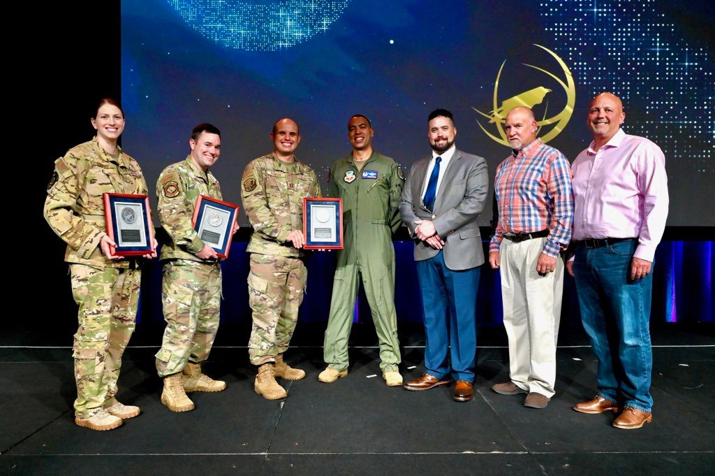 Members from the 850th Spectrum Warfare Group pose for a group photo after receiving awards presented to them by the Association of Old Crows (AOC) at the 59th Annual AOC International Symposium &amp; Conference, Washington D.C., Oct. 26, 2022.<em> <em>Credit: U.S. Air Force photo by 1st Lt. Benjamin Aronson</em></em>