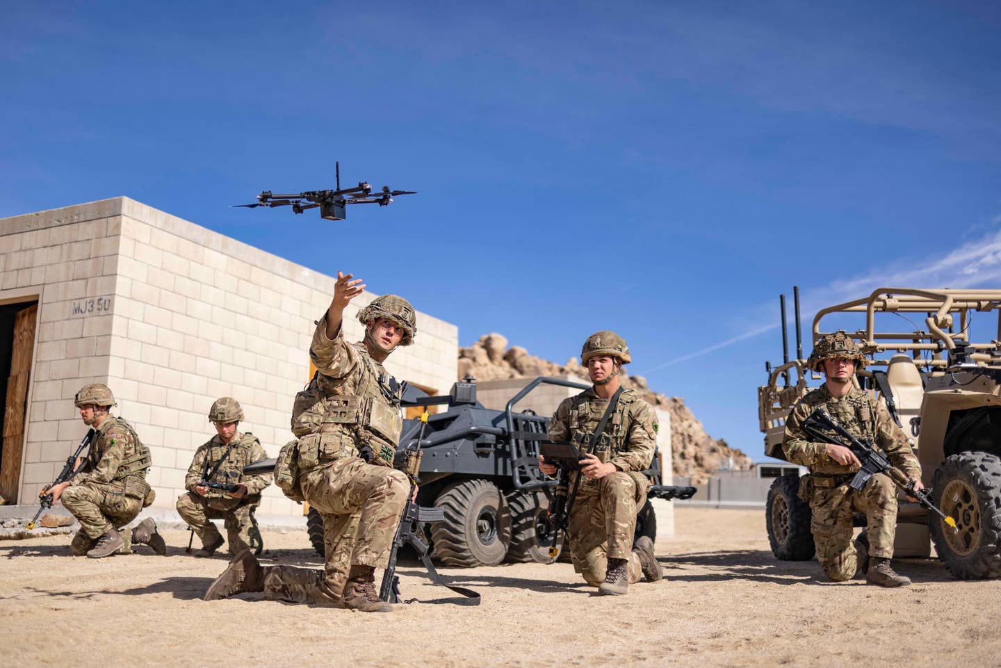 British soldiers launch a SkyDIO unmanned aerial vehicle (UAV) during Project Convergence 22 at Fort Irwin, California. <em>Army Futures Command</em>