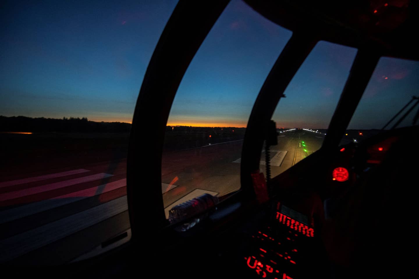 A view from the cockpit of a French Navy Atlantique 2 as the sun rises on Lann-Bihoué naval air base, June 16, 2022. <em>Photo by FRED TANNEAU/AFP via Getty Images</em>