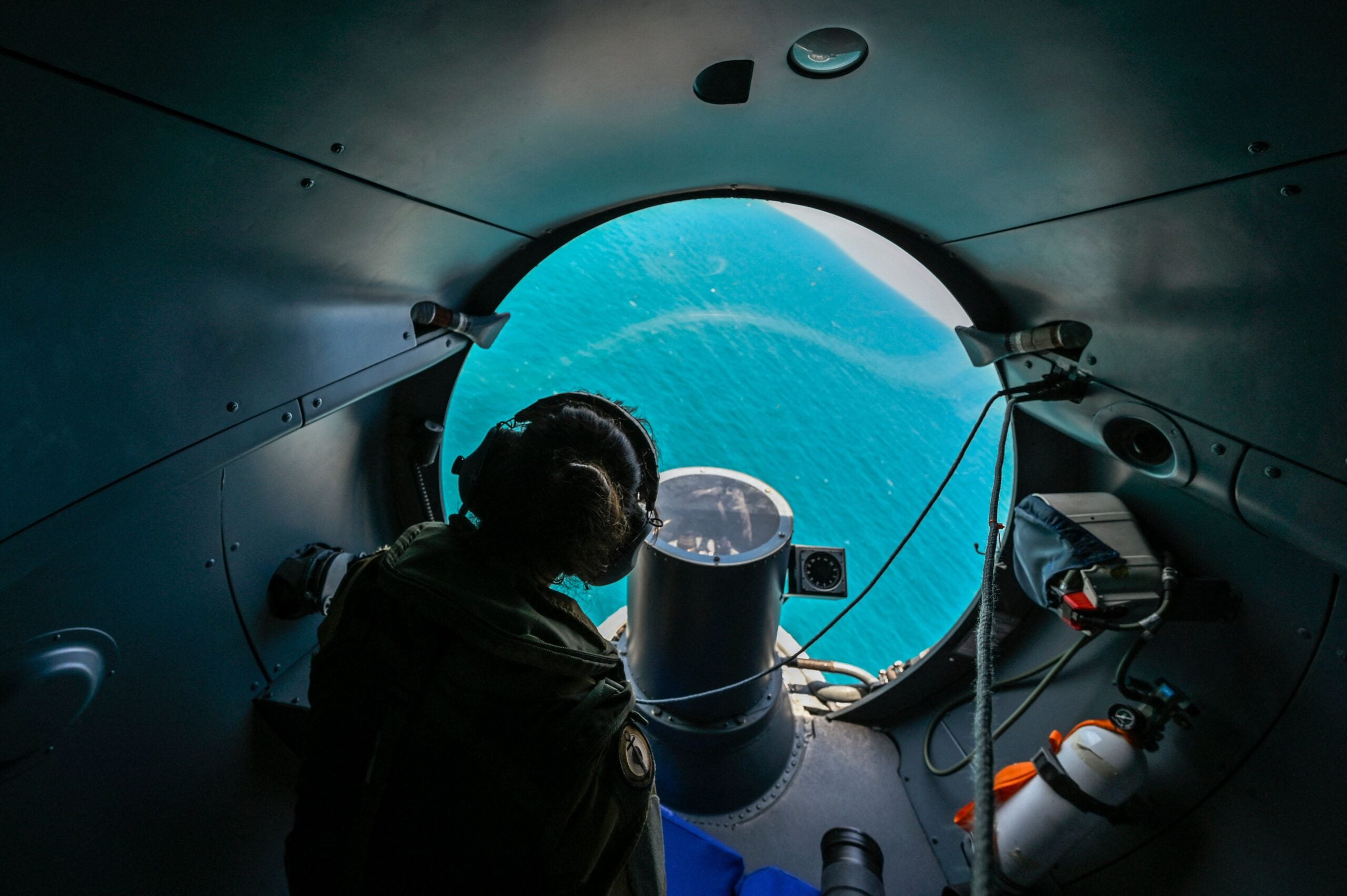A crew member watches from onboard French long-range maritime patrol aircraft Atlantique 2 (ATL 2 ) as it flies over the Black Sea Black sea on July 21, 2022. - The Altantique 2 navy patrol airplane takes part in the annual Breeze naval exercise in the Black Sea , off the coast of Bulgaria, with participation of eleven NATO member coutries. (Photo by Louisa GOULIAMAKI / AFP) (Photo by LOUISA GOULIAMAKI/AFP via Getty Images)