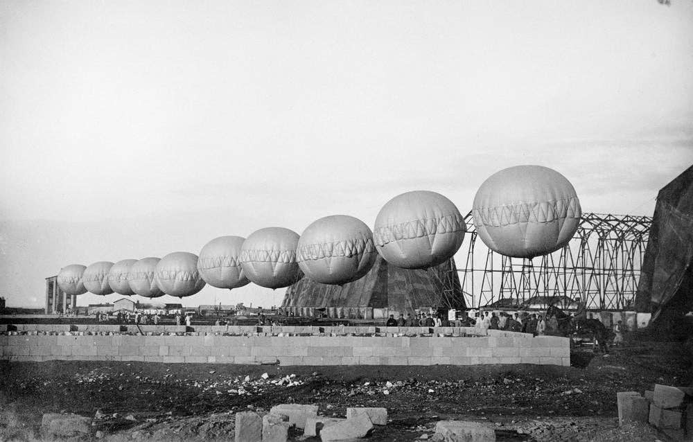 A row of spherical barrage balloons used for suspending aerial nets. (Credit: Australian War Memorial/Wikimedia Commons)