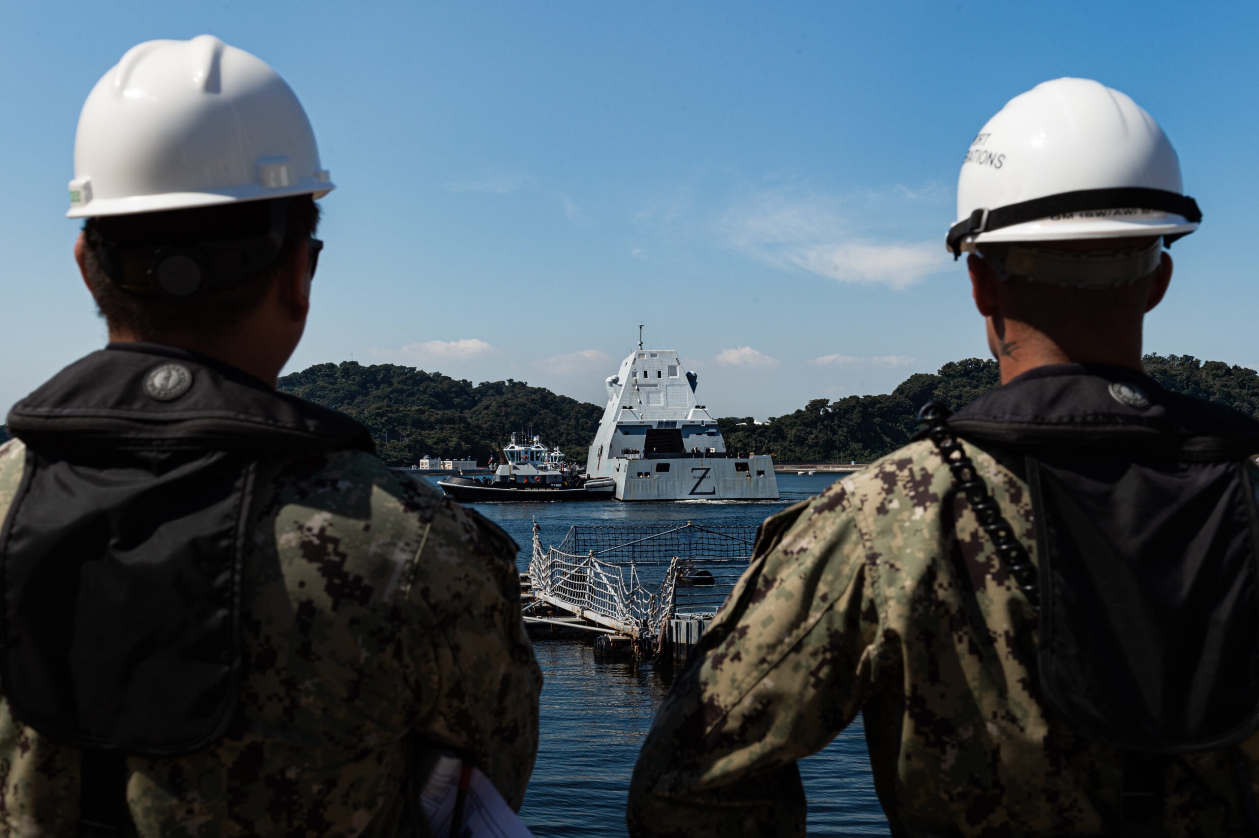 YOKOSUKA, Japan (Sept. 26, 2022) Operations Specialist 2nd Class Kitowel Flores and Quartermaster 2nd Class Milo Mai assigned to Commander, Fleet Activities Yokosuka (CFAY) Port Operations, communicate with harbor tugs escorting the Zumwalt-class guided-missile destroyer USS Zumwalt (DDG 1000) For more than 75 years, CFAY has provided, maintained, and operated base facilities and services in support of the U.S. 7th Fleet's forward deployed naval forces, tenant commands, and thousands of military and civilian personnel and their families. (U.S Navy photo by Seaman Darren Cordoviz)