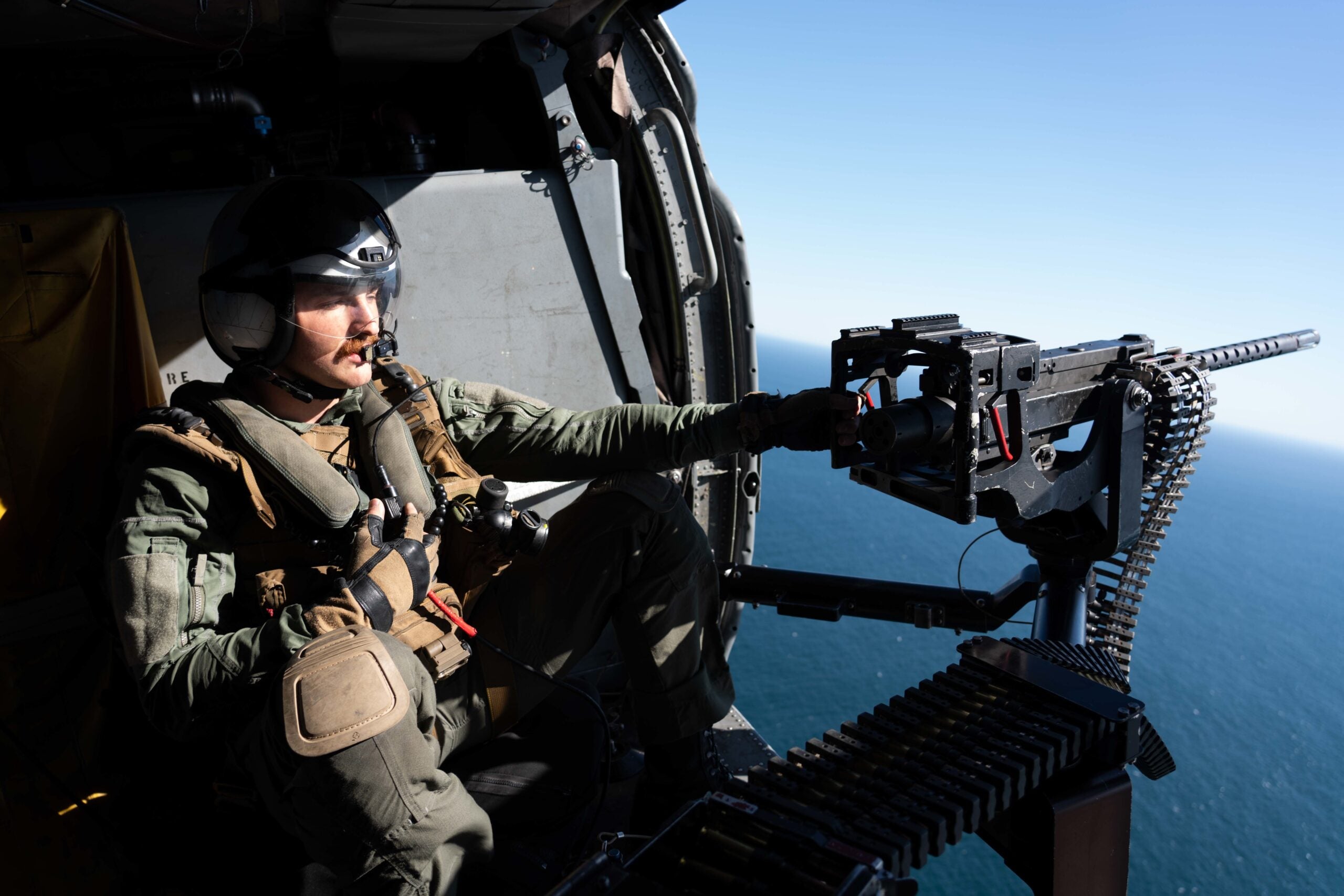 PACIFIC OCEAN (April 18, 2021) Naval Aircrewman (Helicopter) 2nd Class Daniel Ayres, from Fresno, Calif., assigned to Helicopter Sea Combat Squadron (HSC) 21, operates a GAU-21 .50-caliber machine gun in an MH-60S Sea Hawk during a live-fire exercise with the amphibious assault ship USS Essex (LHD 2). Essex is underway conducting routine operations in U.S. 3rd Fleet. (U.S. Navy photo by Mass Communication Specialist Seaman Sang Kim)