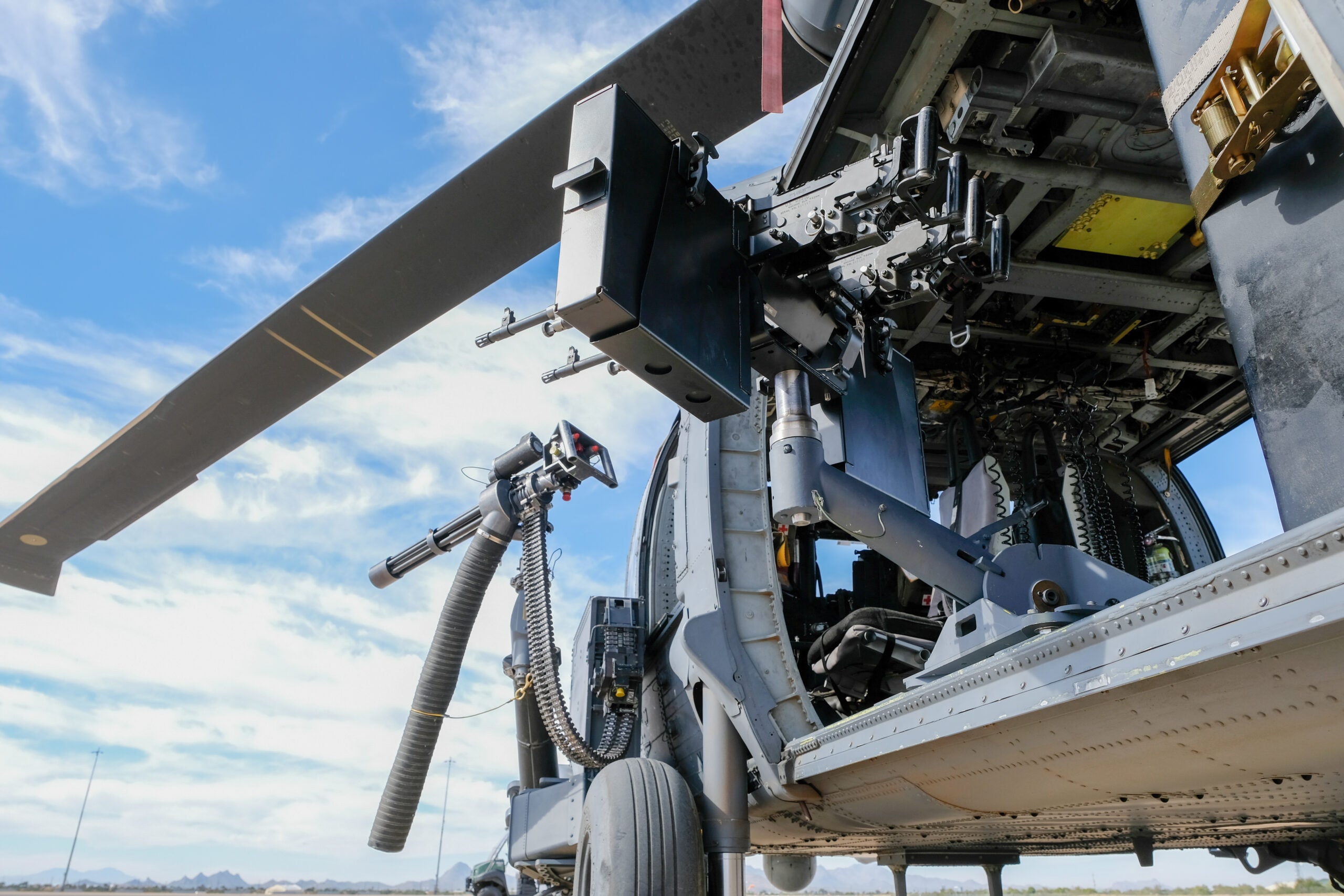 943d Rescue Group Airmen mount two M240s into an HH-60G Pave Hawk helicopter Nov. 22, 2022, at Davis-Monthan Air Force Base, Arizona. The 943d Rescue Group designed a concept to mount four additional M240 machine guns onto the HH-60G helicopters to provide more firepower to the 920th Rescue Wing’s personnel recovery task force in contested environments. (U.S. Air Force photo by Andre Trinidad)