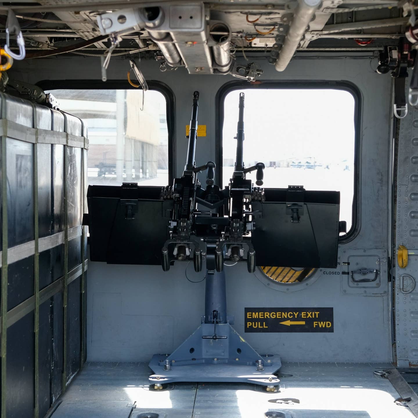 How the gun mount appears in the HH-60G's doorway with the doors closed. The floor bracket, base, and mount pulled from military stocks can be seen. <em>Credit: U.S. Air Force photo by Andre Trinidad</em>