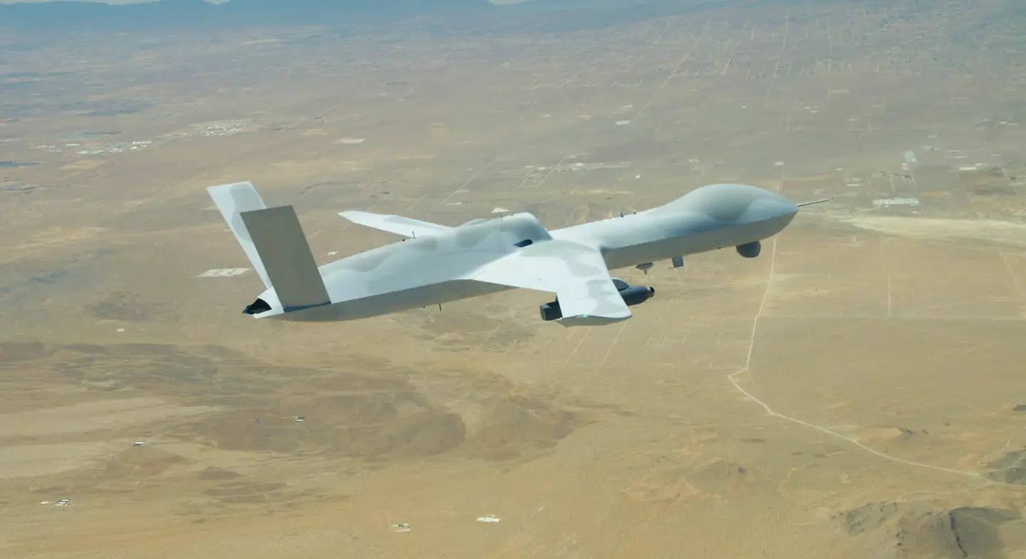 A General Atomics Avenger drone carrying a <a href="https://www.twz.com/40980/legion-infrared-search-and-track-pods-can-now-carry-their-own-datalinks-for-more-lethal-targeting">Lockheed Martin Legion</a> infrared search and track pod during a flight test,&nbsp;<em>GA-ASI</em>