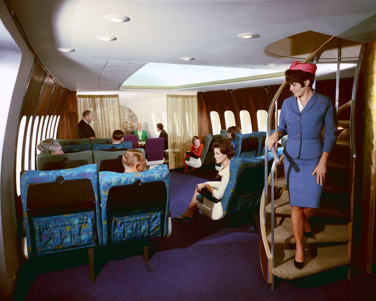 An early 747 cabin configuration, with the stairs leading to the upper deck. <em>Boeing</em>