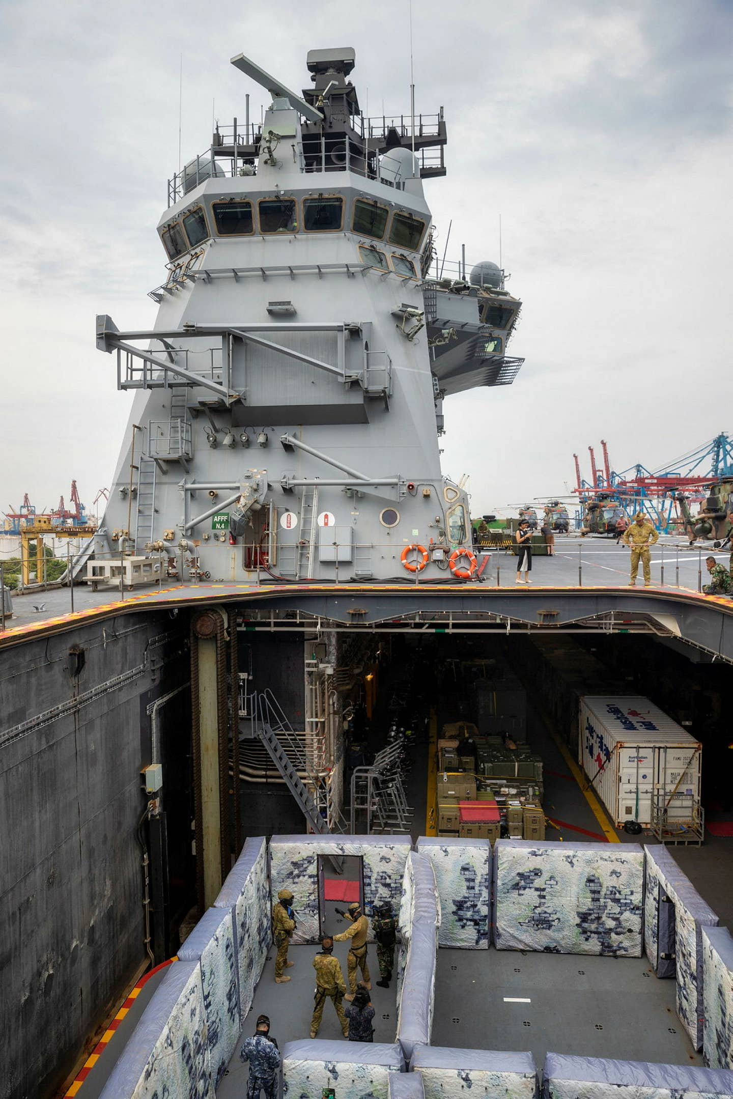 The shoot house setup on the aircraft elevator ahead of the vessel's island. The elevator is seen in its lowered position. <em>Australian Department of Defense.</em>
