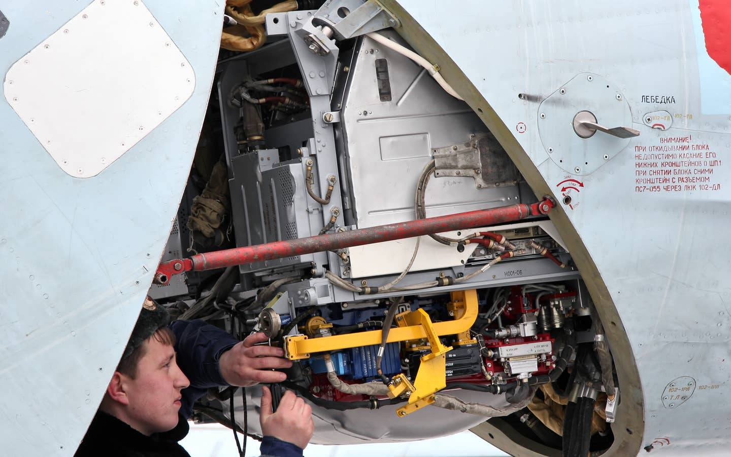 A maintainer works on the radar of a Su-27SM at Khotilovo Airbase in 2011. <em>Vitaly V. Kuzmin/Wikimedia Commons</em>