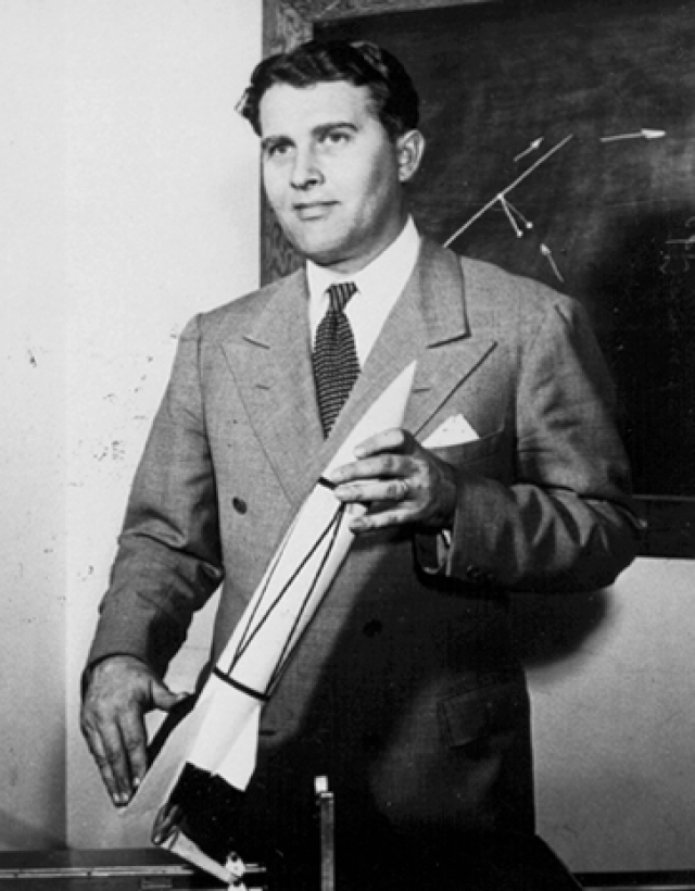 Wernher von Braun holding a model of the V-2 rocket. <em>NASA.</em>