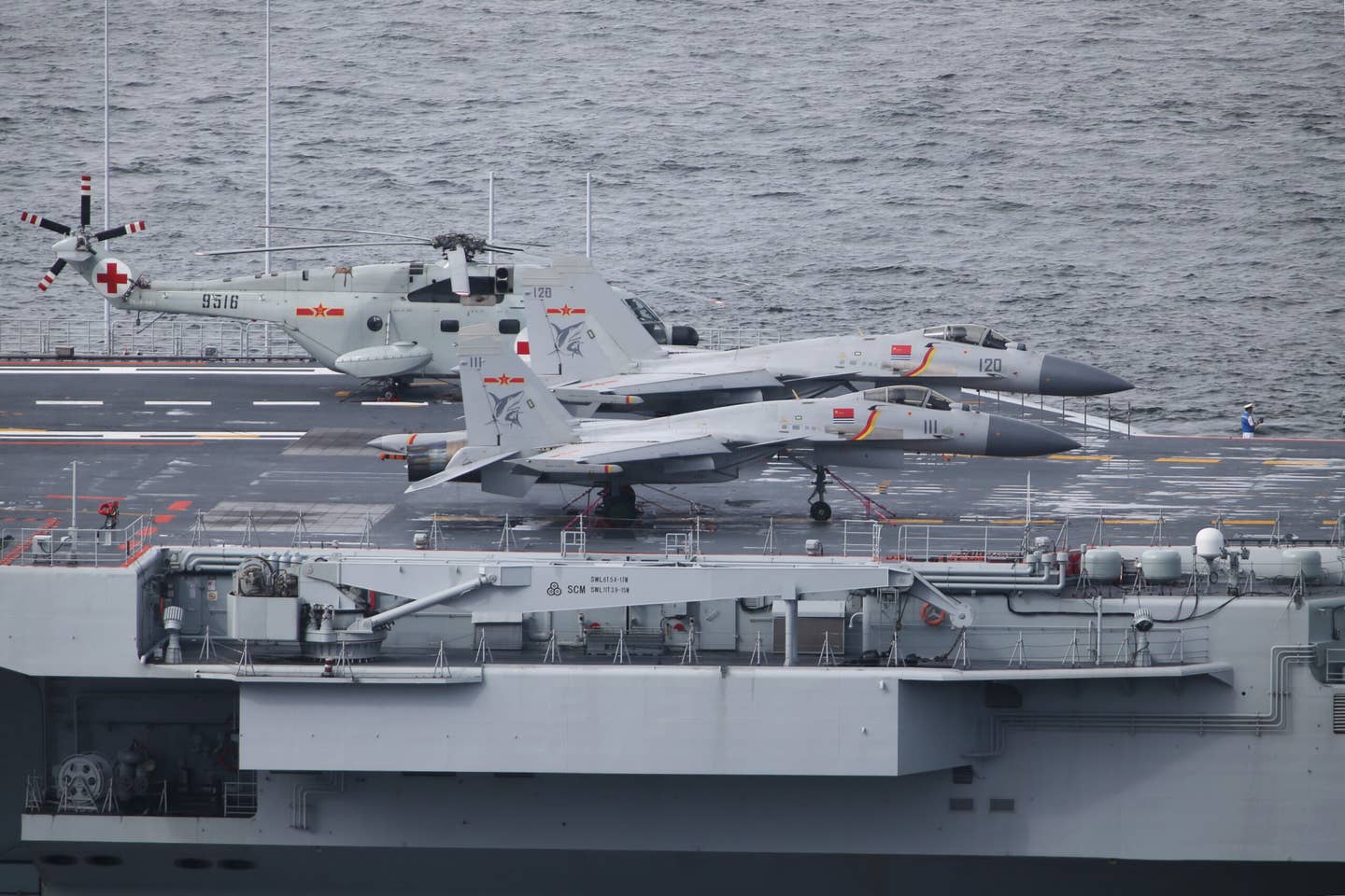 J-15 fighter jets and a Z-8JH&nbsp;search and rescue helicopter on the deck of Liaoning, the first PLAN first aircraft carrier. <em>Photo by SAM TSANG/South China Morning Post via Getty Images</em>
