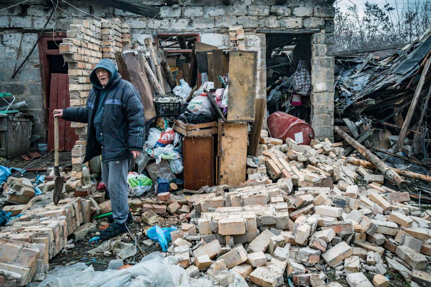 A man tries to recover after his home was destroyed by Russian shelling in Kostiantynivka, a village in the Donbas region. (Photo by Celestino Arce/NurPhoto via Getty Images)