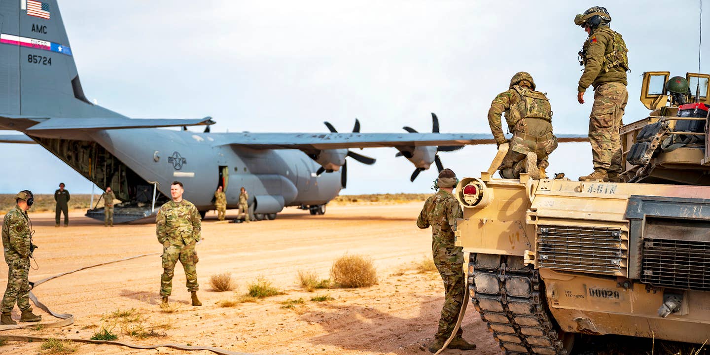 Army and Air Force team up to simulate hot pit refueling an M1A2 Abrams tank with a C-130J Super Hercules