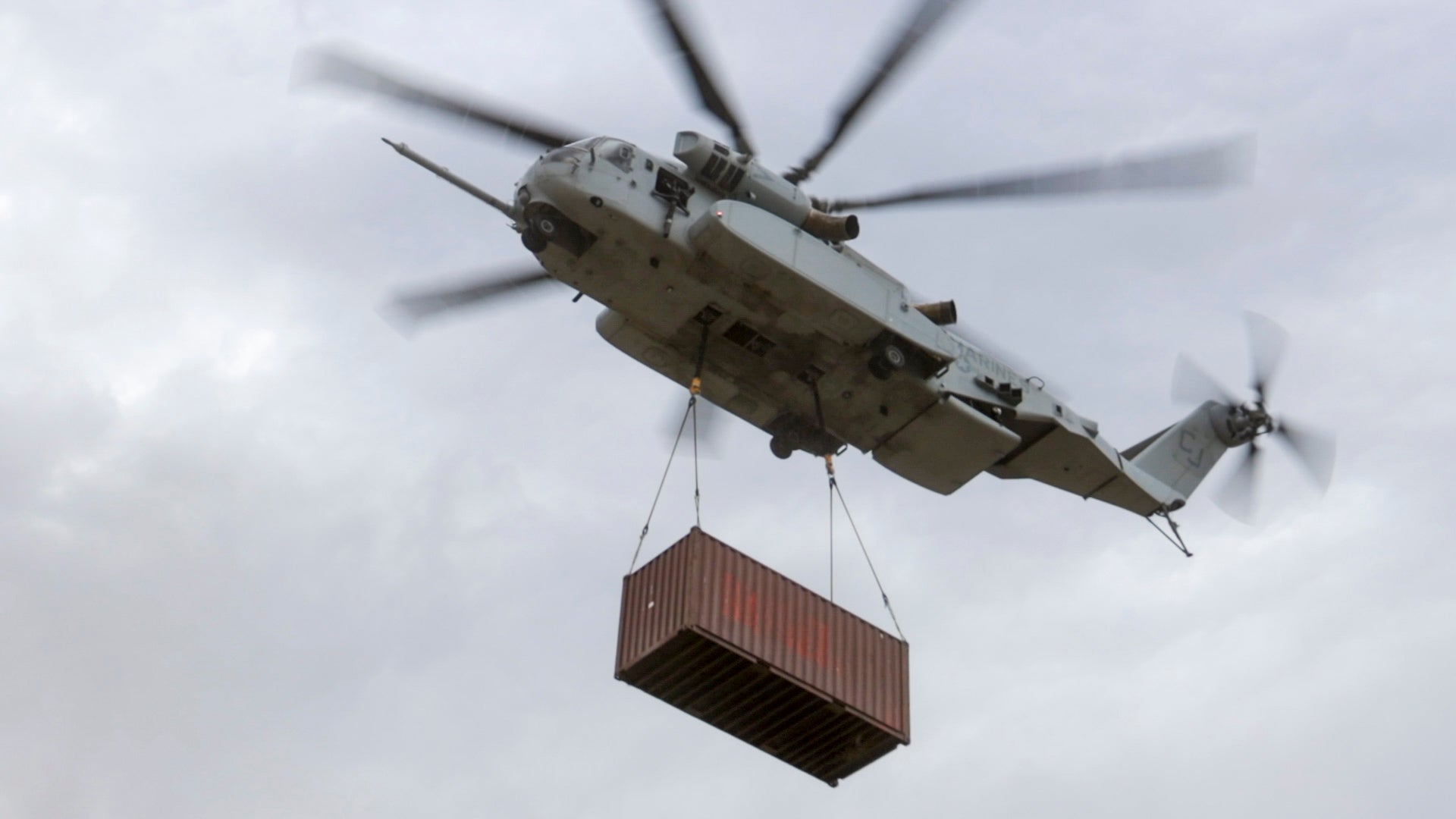 U.S. Marines with Marine Heavy Helicopter Squadron (HMH) 461 carry a cargo container with a CH-53K King Stallion at Mountain Home Air Force Base, Idaho, Aug. 11, 2022. This was the first time the Marine Corps deployed the King Stallion in an exercise. HMH-461 is a subordinate unit of 2nd Marine Aircraft Wing, the aviation combat element of II Marine Expeditionary Force. (U.S. Marine Corps photo by Cpl. Adam Henke)
