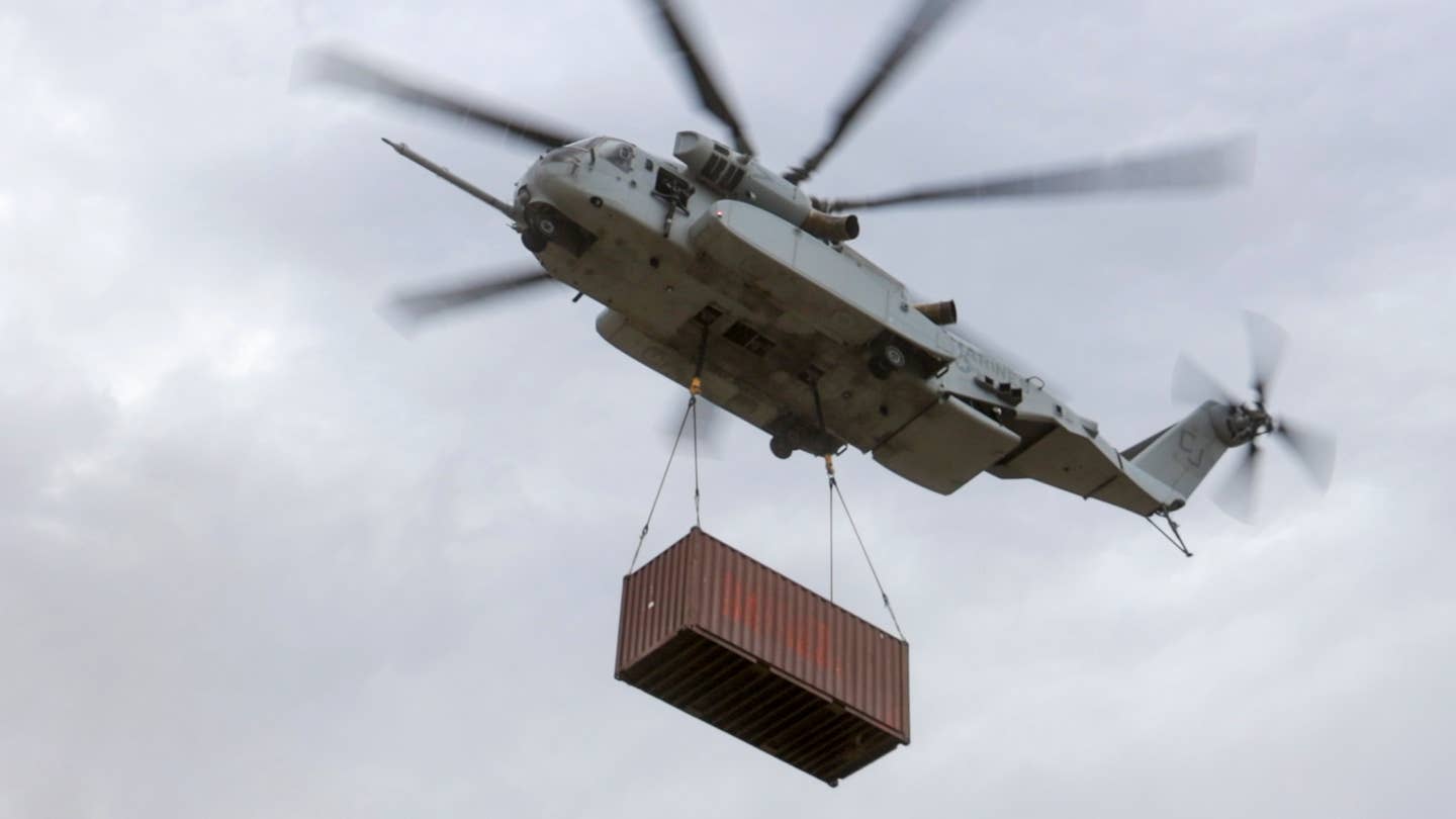 U.S. Marines with Marine Heavy Helicopter Squadron (HMH) 461 carry a cargo container with a CH-53K King Stallion at Mountain Home Air Force Base, Idaho, Aug. 11, 2022. <em>U.S. Marine Corps photo by Cpl. Adam Henke</em>