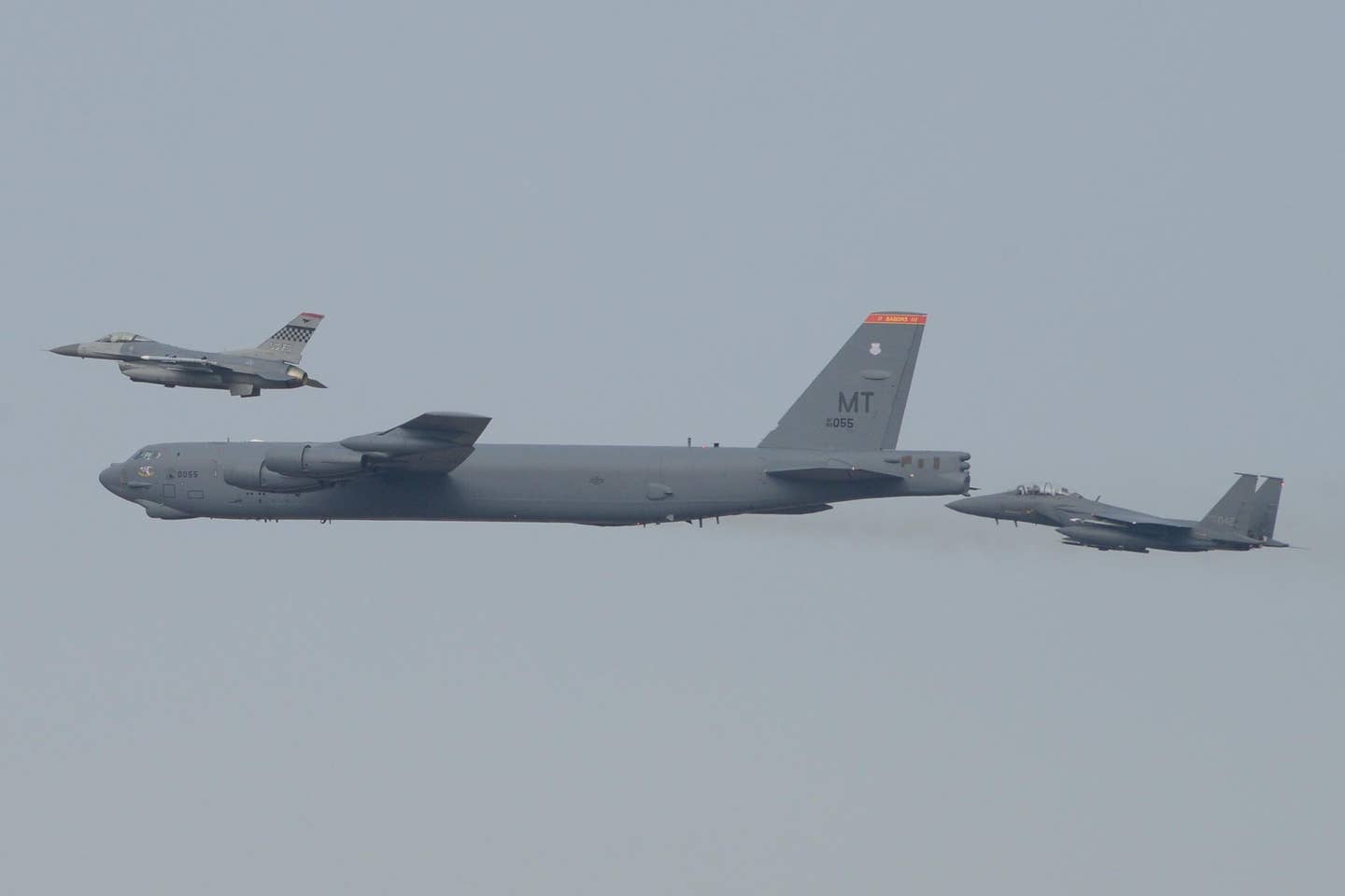 A U.S. Air Force B-52H strategic bomber from Andersen Air Base, Guam, conducts a low-level flight in the vicinity of Osan, South Korea, in response to provocative actions by North Korea, in 2016. The B-52 was joined by a South Korean F-15K Slam Eagle and a U.S. Air Force F-16. <em>U.S. Air Force photo by Airman 1st Class Dillian Bamman/Released</em>