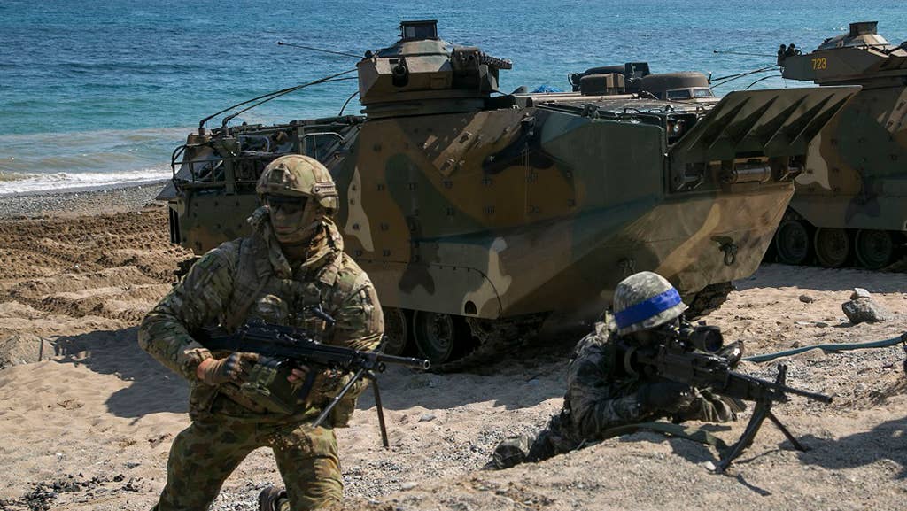 Soldiers from the U.S. Marine Corps, Republic of Korea Marine Corps, New Zealand Army, and Australian Army conduct amphibious assault training at Doksukri Beach, South Korea, during a military exercise in 2016. <em>U.S. Marine Corps photo by Sgt. Briauna Birl/RELEASED</em>