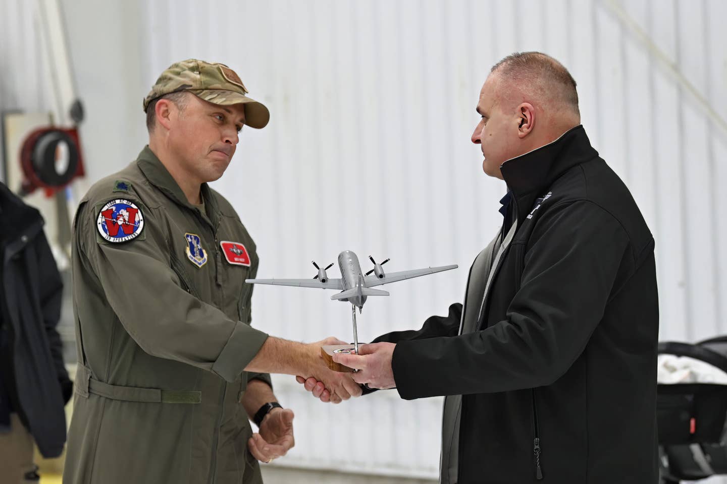 U.S. Army Col. Paul Felician, director of the Wisconsin National Guard’s Counter Drug Program, right, recognizes Lt. Col. Benjamin West, Wisconsin RC-26 Program Manager, following the final flight of the state’s RC-26B on December 28, 2022. <em>U.S. Air National Guard photo by Staff Sgt. Cameron Lewis</em>