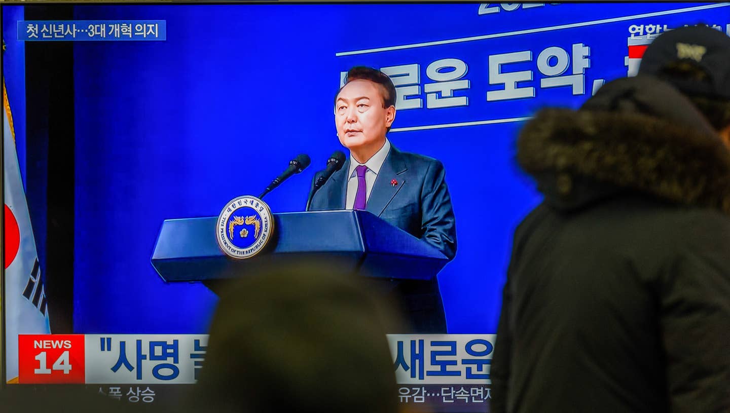 A TV screen shows footage of South Korean President Yoon Suk Yeol’s New Year’s address during a news program at the Yongsan Railway Station in Seoul. <em>Photo by Kim Jae-Hwan/SOPA Images/LightRocket via Getty Images</em>
