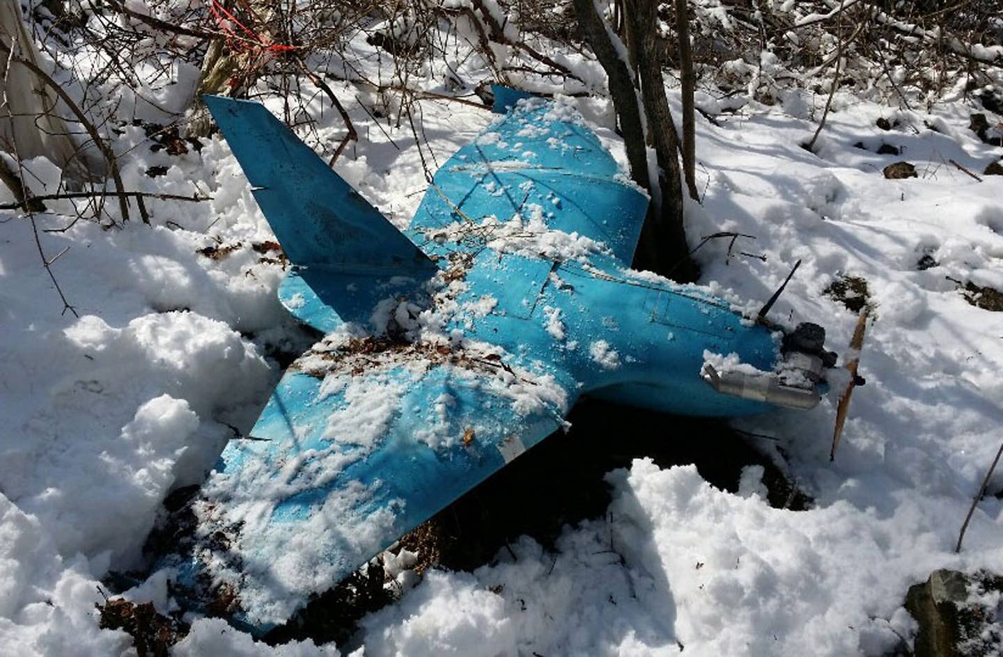 The wreckage of a crashed North Korean drone seen on a mountain in Samcheok, South Korea, back April 2014. This was one of three such drones found in South Korea around that period. <em>Photo by Handout/South Korean Defence Ministry via Getty Images</em>