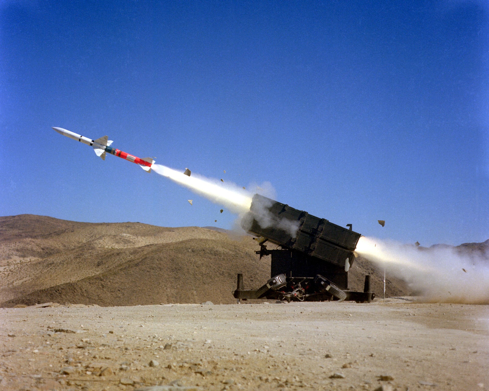 A left side view of an AIM-7F Sparrow III air-to-air missile being launched from a Skyguard missile launcher.