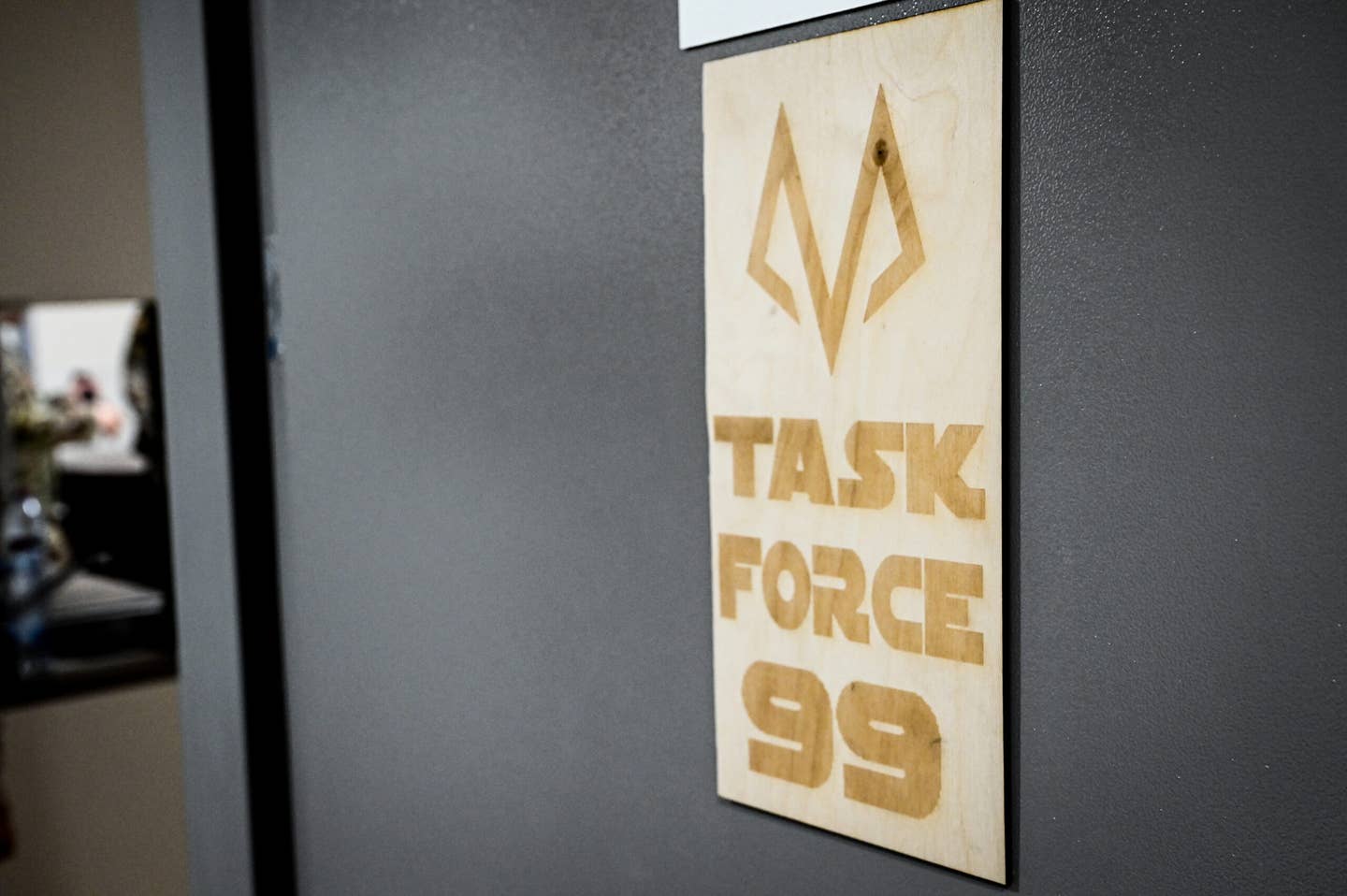 A Task Force 99 sign hangs on the door to the team’s work center at Al Udeid Air Base, Qatar, October 28, 2022. <em>Credit: U.S. Air Force photo by Staff Sgt. Cassandra Johnson</em>