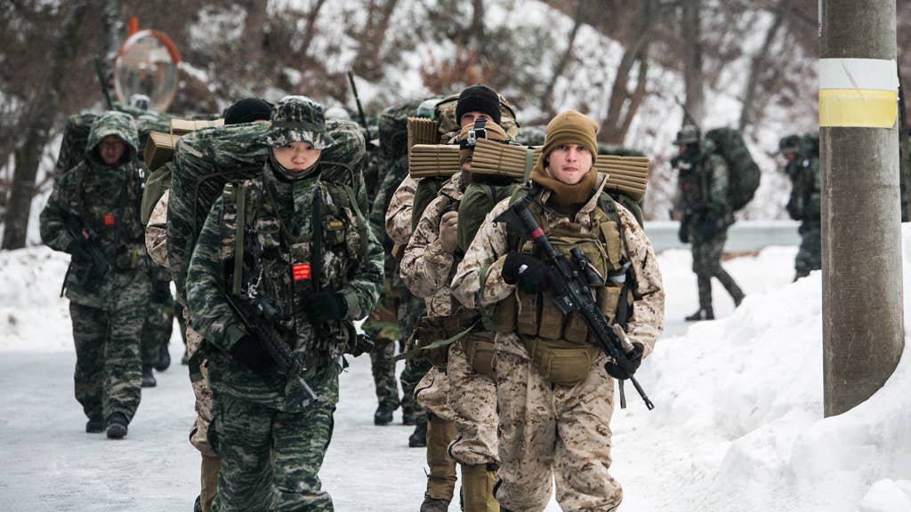 U.S. and Republic of Korea Marines hike up a mountain during the Korean Marine Exchange Program in Pyeongchang, South Korea. <em>U.S. Marine Corps photo by Cpl. Tyler S. Giguere/Released</em>
