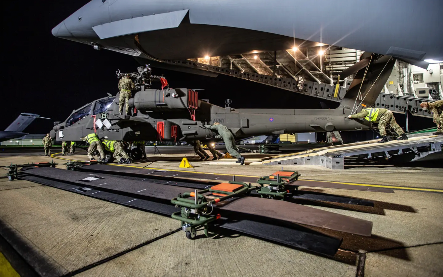 A U.K. AH-64E is offloaded from a C-17. The United Kingdom selected the baseline JAGM to army its E-model Apaches.&nbsp;<em>Crown Copyright</em>