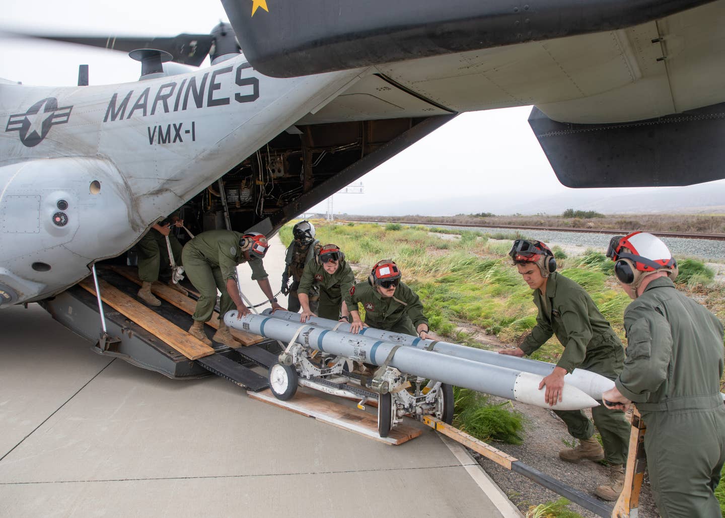 Marines offload AIM-120 AMRAAMS from an MV-22 doing Obsidian Iceberg. (Author's image)