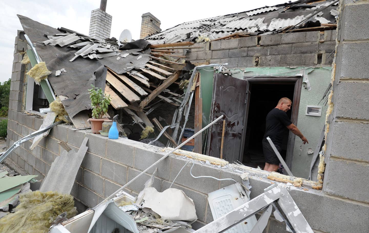 A man stands on July 13, 2014, in a house destroyed after bombardments in the village of Maryinka. (DOMINIQUE FAGET/AFP via Getty Images)