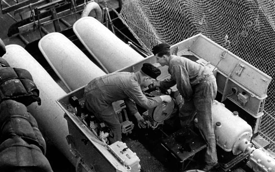 Crewmen aboard the flagship <em>Admiral Hipper</em> working on the open control position of the triple torpedo mount in 1940, during the invasion of Norway. <em>© Steve Backer</em>, <em>Admiral Hipper Class Cruisers  </em>