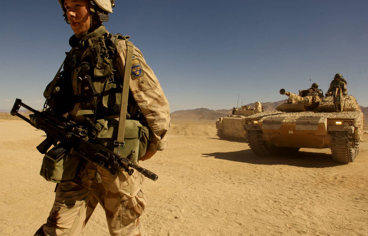 A Swedish Army soldier leads a CV9040C out of a simulated forward deployed location at the National Training Center in Fort Irwin, California, in 2007, during Exercise Bold Quest. <em>U.S. Air Force</em>