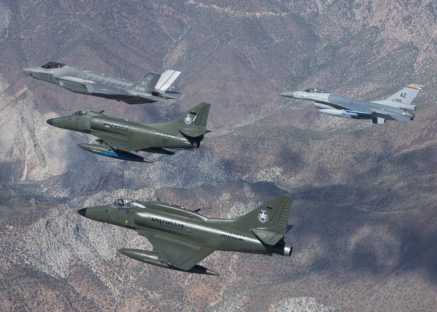 A Dutch F-35A, a Dutch F-16, and a Draken A-4 Skyhawk fly in support of an operational test exercise for the Royal Netherlands Air Force F-35 contingent at Edwards Air Force Base. <em>Frank Crebas</em><br>