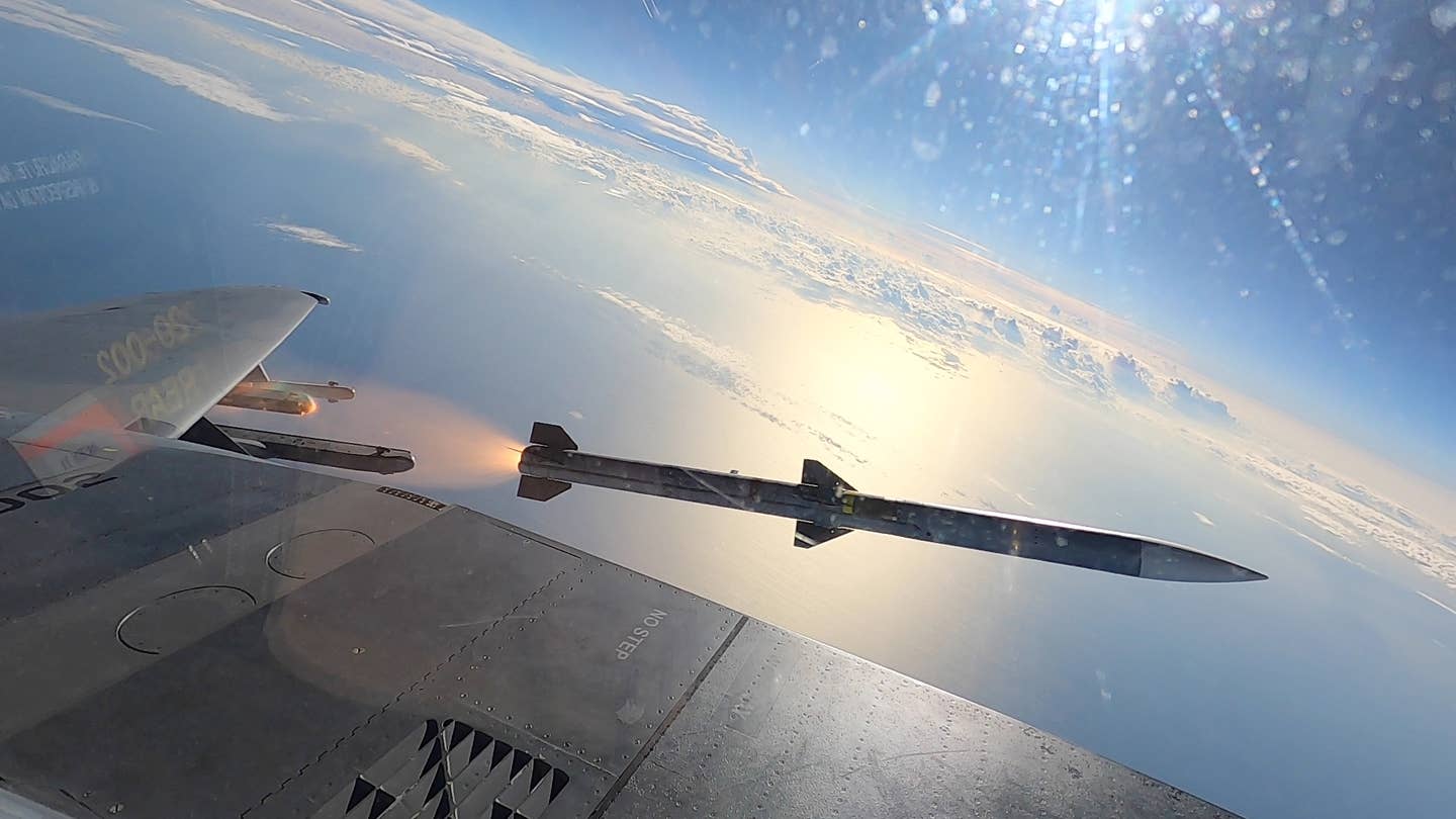 Flying over the Gulf of Mexico, an F-15EX launches an AIM-120 AMRAAM missile from its new weapon stations, known as Stations 1 and 9. <em>U.S. Air Force</em>