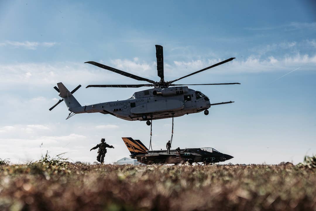 U.S. Marines with Combat Logistics Battalion (CLB) 24, Combat Logistics Regiment 2, 2nd Marine Logistics Group, hook CF-01 to a CH-53K King Stallion for Helicopter Support Team operations. <em>U.S. Marine Corps photo by Cpl. Meshaq Hylton</em>