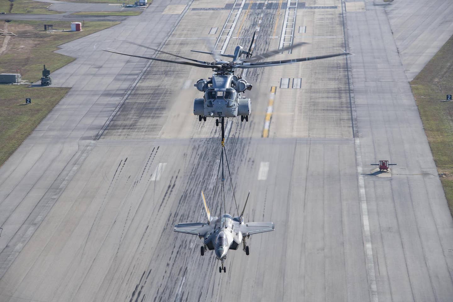 A non-flyable F-35C Lightning II airframe is flown as part of a CH-53K King Stallion external load certification lift, Dec. 13, 2022. <em>U.S. Navy photo by Kyra Helwick</em>