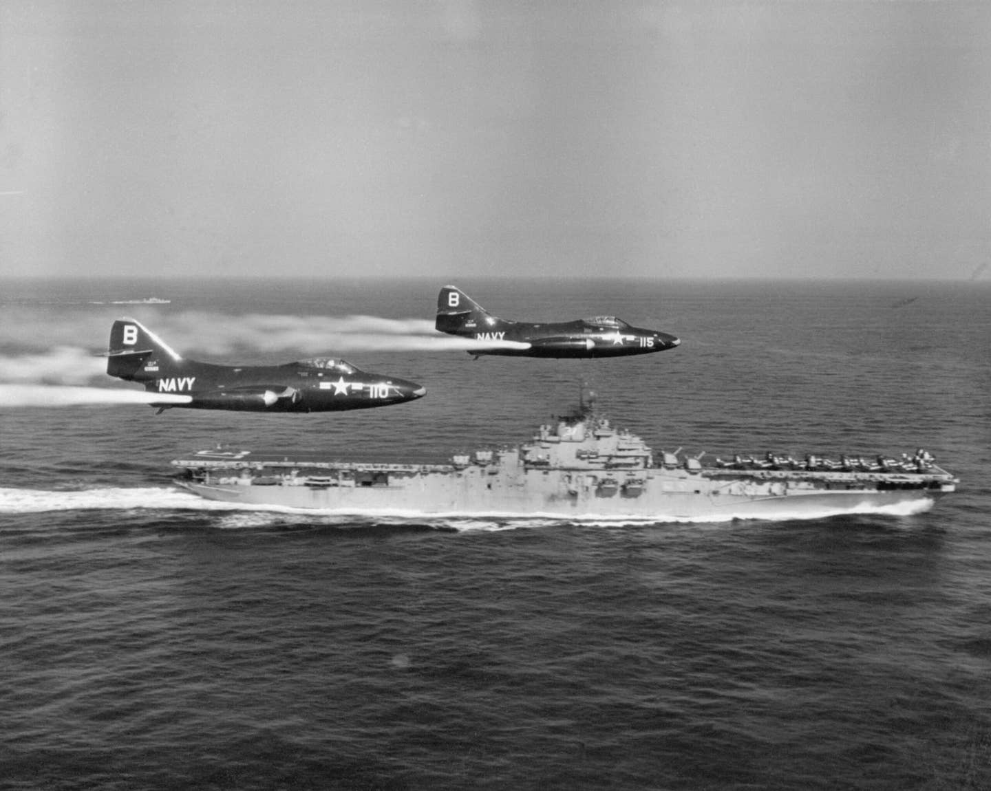 Two F9F Panthers jettison fuel from their tip tanks as they make a pass on the carrier USS <em>Princeton</em>. At the time, the <em>Princeton</em> and other aircraft carriers were operating with Task Force 77. <em>Getty Images</em>